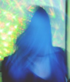 a blurry image of a person in front of a television