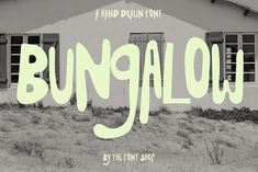 the word bunglow is in front of an old house with grass and bushes