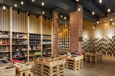 a store filled with lots of wooden pallets next to tall brick pillars and ceiling lights