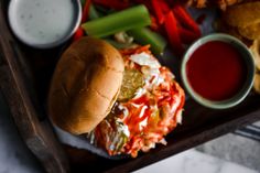 a tray with a sandwich and some dipping sauces