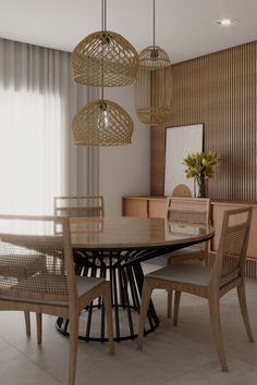 a dining room table with four chairs and a round wooden table surrounded by hanging lights