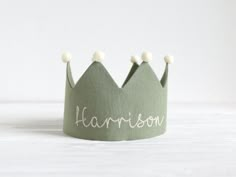 a green crown with the word harrison written on it