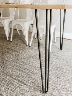 a dining room table with white chairs around it