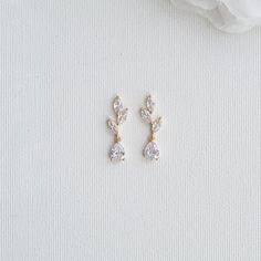 Rose Gold Bridal Earrings Designed With Small Leaves and Drops Beautiful earrings for brides and bridesmaids, designed with small leaves and drops and plated in rose gold. These small-leaf rose gold drop earrings are delicate and sparkly. The earrings offer a simple and elegant look. great to wear with your bridal and bridesmaids' dress and other outfits on any occasion after the wedding. These small drop earrings are made of cubic zirconia, lightweight, comfortable and sparkly, The earrings are Simple Bridal Jewelry Gold, Boho Bridal Earrings Gold, Wedding Jewelry Rose Gold, Dainty Bridal Earrings, Simple Wedding Earrings Gold, Simple Bride Jewelry, Short Dangle Earrings, Elegant Simple Gold Earrings, Dainty Silver Drop Earrings