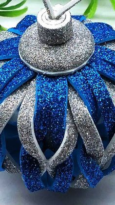 a blue and silver ornament sitting on top of a table