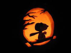 a carved pumpkin with the silhouette of a person holding a baseball bat in front of a full moon