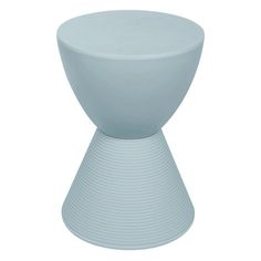 a white vase sitting on top of a table