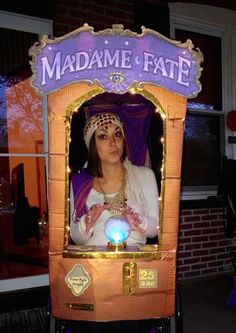 a woman dressed as a mardi gras costume in front of a sign that says madame fate