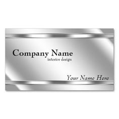 a silver business card with the name of an interior design company, on white background