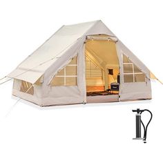 a tent that is set up in the middle of a room with windows on it