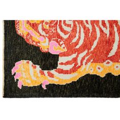 an orange and black rug with a large tiger on it's back side,