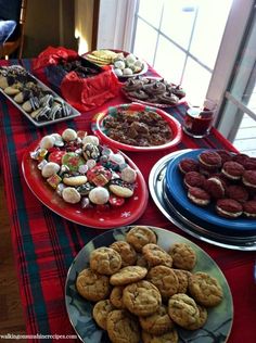 a table topped with plates filled with cookies and pastries