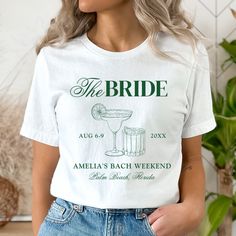 a woman wearing a white t - shirt that says the bride with an image of a cocktail on it