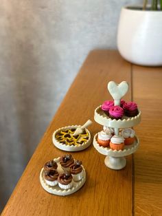 two miniature cakes and pastries on a wooden table