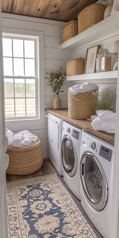 a washer and dryer in a small room with wood flooring on the walls