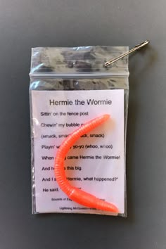 a plastic bag with an orange worm on it's side and the words, hermie to the womanie