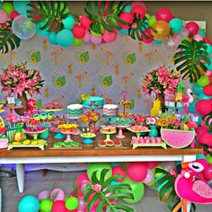 a tropical themed birthday party with balloons and decorations