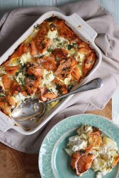 a casserole dish with broccoli and carrots in it on a blue plate