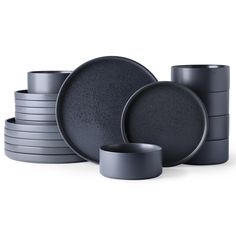 a stack of black plates and cups sitting next to each other