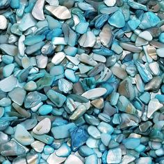 blue and white glass pebbles are stacked together