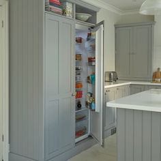 an open refrigerator in the middle of a kitchen