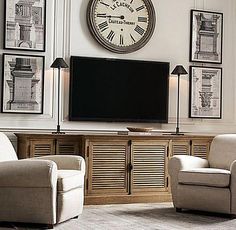 a living room with a large clock on the wall