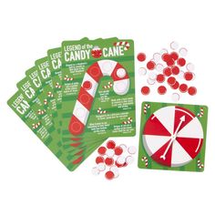 candy canes and candies are on top of the card game cards for christmas