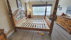 a bed room with a neatly made bed and dressers