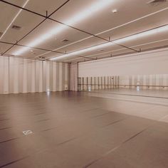 an empty room with white walls and flooring is shown in sepia - toned photograph