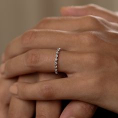 a woman's hand with a diamond ring on it