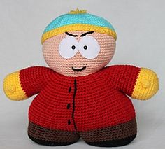 a knitted doll with a blue hat and red jacket