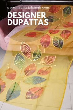 an image of a table with paper leaves on it and the words designer dupatass