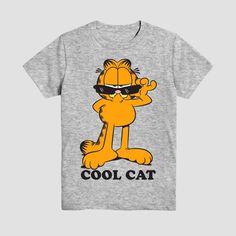 Your kid can show their love for the iconic cartoon cat with this Garfield Cool Cat Short-Sleeve Graphic T-Shirt. Made of 100% cotton, this mid-length T-shirt features Garfield along with the text "cool cat." Tailored in a standard fit, this graphic T-shirt includes a banded collar neckline and long sleeves for an elevated look. Plus, the pullover style makes it easy to wear. Text Cool, Iconic Cartoon, Trending Graphic Tees, Fun Texts, Kids Clothes Boys, Top Graphic Tees, Boys Long Sleeve, Fabric Names, Cartoon Cat