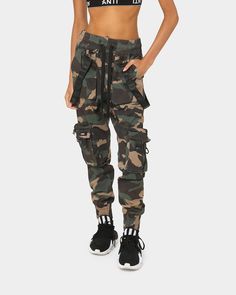 The Armed Forces Elite Joggers are ready to be deployed to your wardrobe. Cargo pockets and strap details pair with a camo print for the ultimate pair of pants. - Elasticated waistband with drawstring - Fixed tabs with metal buttons to waistband - Removable Anti Order straps - Camo print allover - Elastic cuffs - Dual front pockets - Dual cargo pockets to leg - Zip details to cargo pockets - Anti Order branding - Regular fit - Colour: Woodland Camo - Style: AOARMEDFRCSELTJG Camo Fashion, Woodland Camo, Fashion Portfolio, Culture Kings, Pair Of Pants, Camo Print, Armed Forces, Metal Buttons, Cargo Shorts