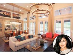 a living room filled with furniture and a chandelier hanging over the top of it