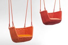 two swings made out of wicker hanging from strings, one orange and the other yellow