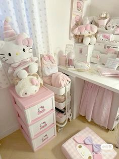 a hello kitty themed bedroom with pink furniture and accessories on the desk, along with other items