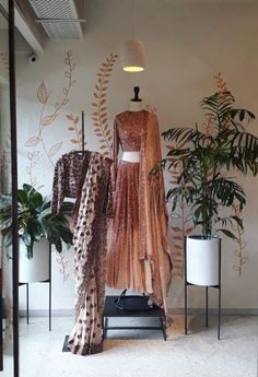 a dress on display in a room with plants