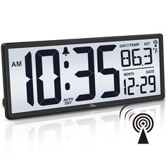 an alarm clock with the time displayed on it's display and wi - fi antenna