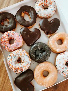 a box filled with lots of different flavored donuts