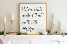 a white fireplace mantel topped with christmas decorations and a framed sign that says silver wrote winter that melts into spring