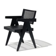 a black chair sitting on top of a white floor