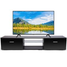 a flat screen tv sitting on top of a black entertainment center next to a lake