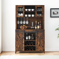 a wooden cabinet filled with bottles and glasses