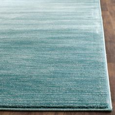 a blue rug on top of a wooden floor