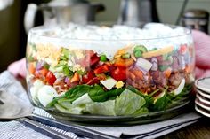 a salad in a glass bowl on top of a table