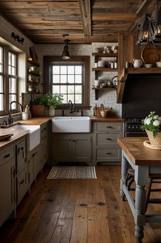 a rustic kitchen with wooden floors and white walls is pictured in this image, there are many open shelvings on the wall