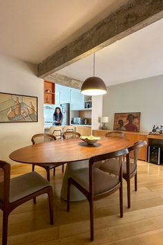 a wooden table with chairs around it in a room