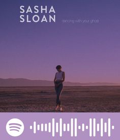 a woman standing in the middle of a desert with an equal sound on her chest