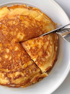 pancakes on a white plate with a fork